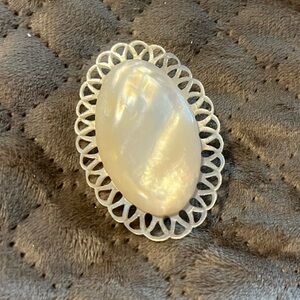 Hand carved mother of pearl brooch.